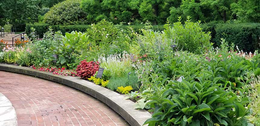 curving brick pathway and flower bed