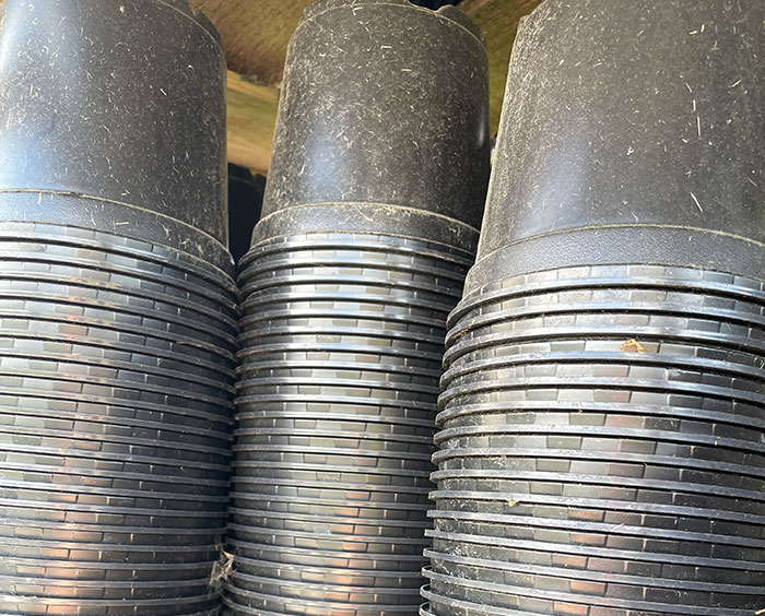 stacked black plastic pots