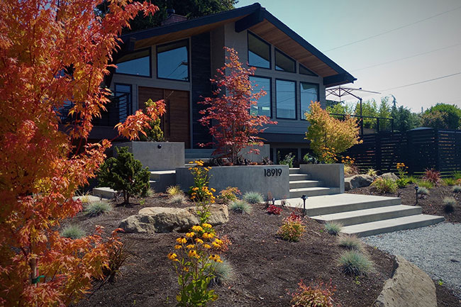 Front of home with fall color in trees, steps and gravel walk way