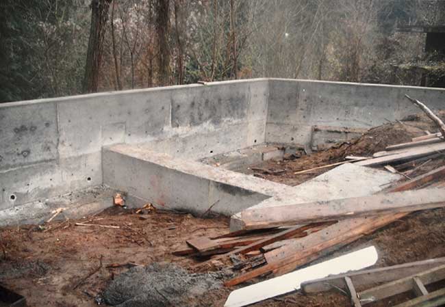 Photo of the construction of a concrete retaining wall and anchor in the author’s back yard.