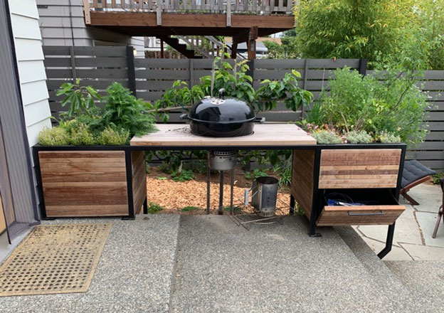 Finished construction with a built-in Weber grill and a charcoal drawer!