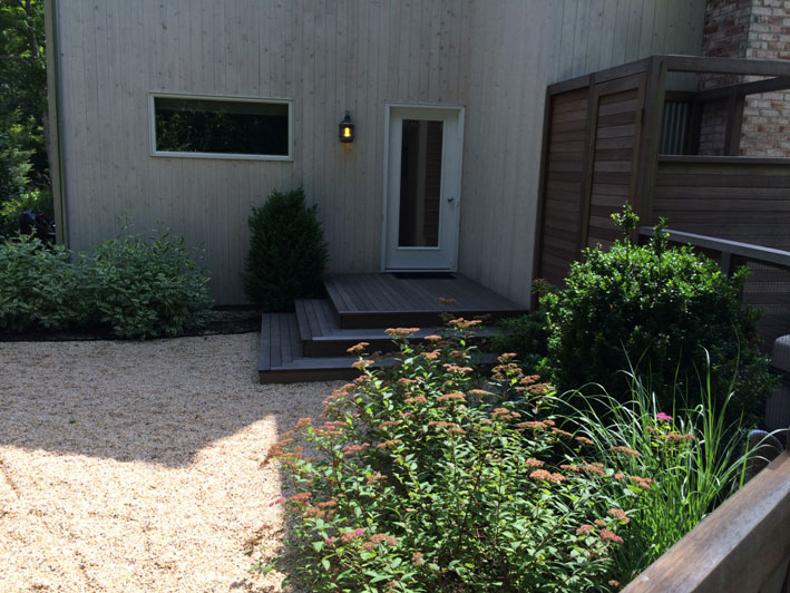 backyard landscape design, back landing with shrubs and gravel path